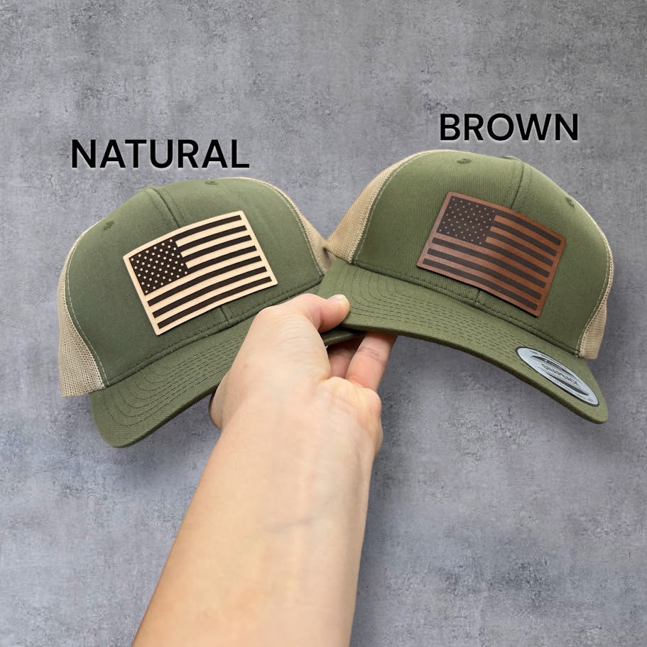 Two Green Branded Leather Patch Hats, One with a Natural Colored Patch and the Other Brown Colored Patch