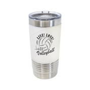 A personalized stainless steel insulated volleyball tumbler with a clear lid and a textured volleyball wrap with a custom engraved logo.