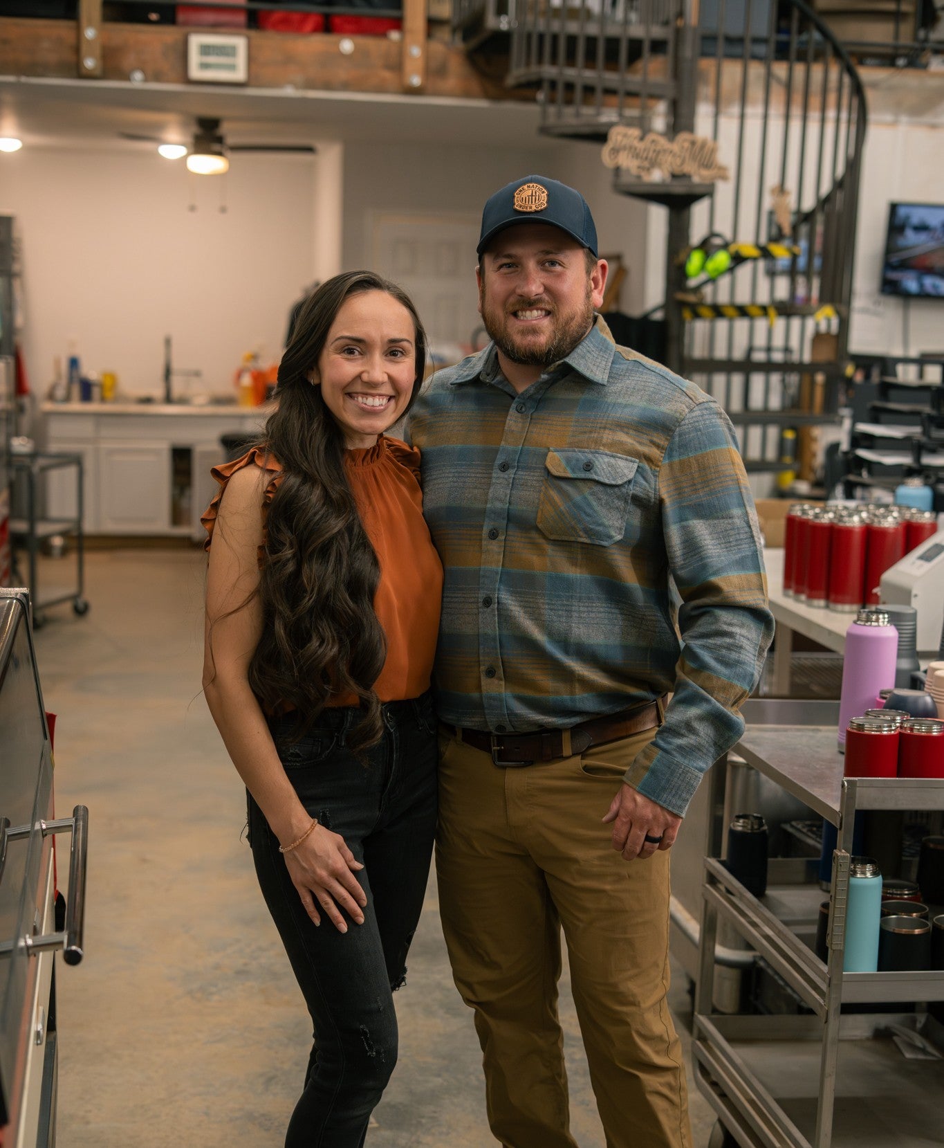 Two people standing together in a workshop